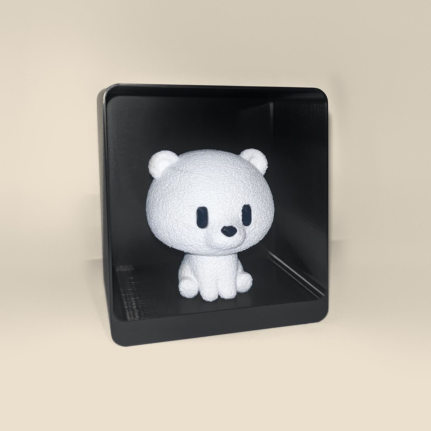 3D-printed polar bear figurine, angled view: a white polar bear with black eyes and nose