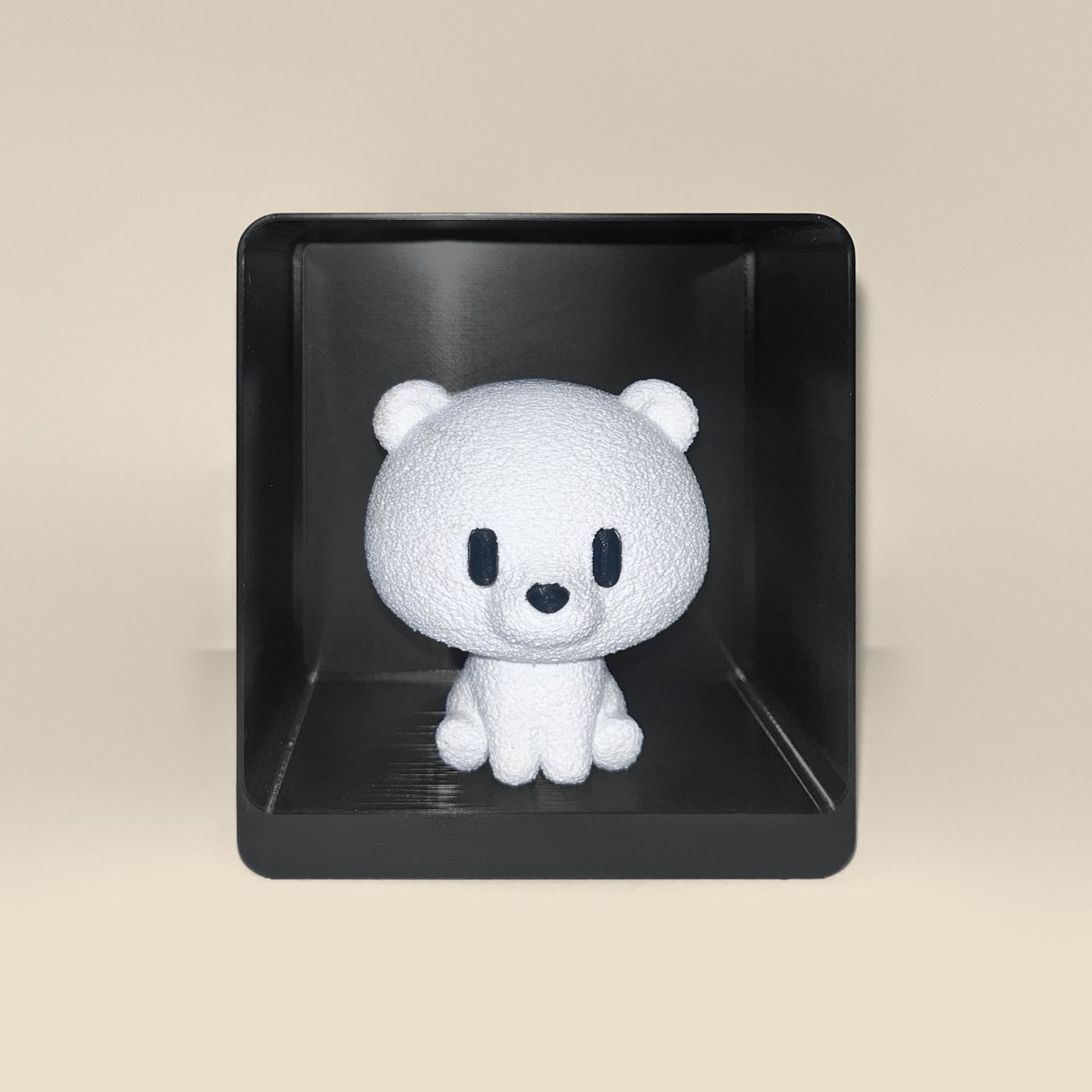 3D-printed polar bear figurine, front view: a white polar bear with black eyes and nose