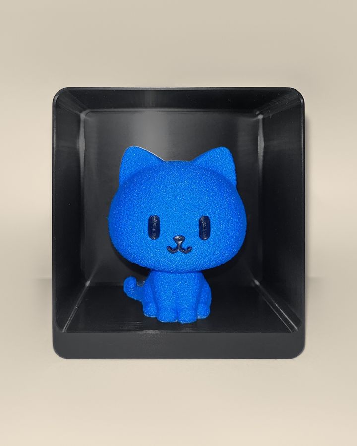 3D-printed cat figurine, front view: a blue cat with black eyes and a smiling mouth