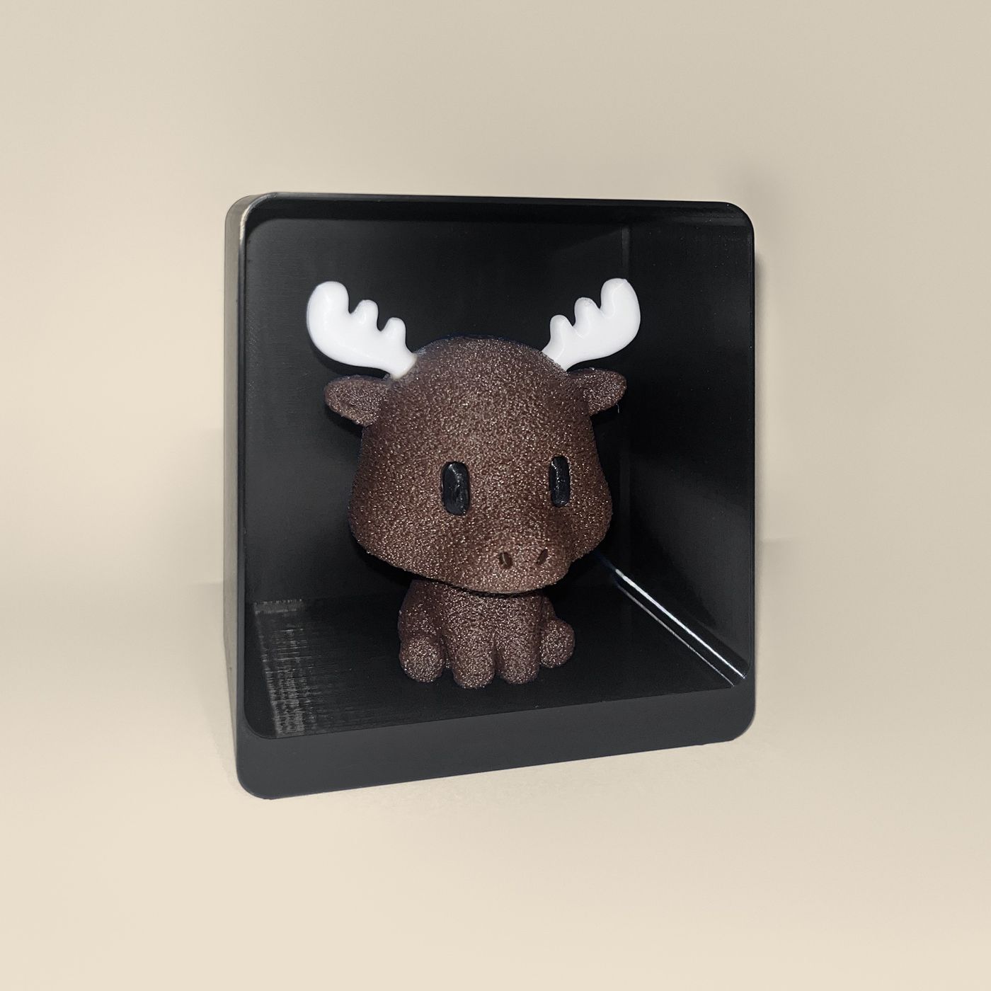 3D-printed moose figurine, angled view: a brown moose with white antlers