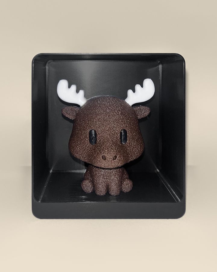 3D-printed moose figurine, front view: a brown moose with white antlers